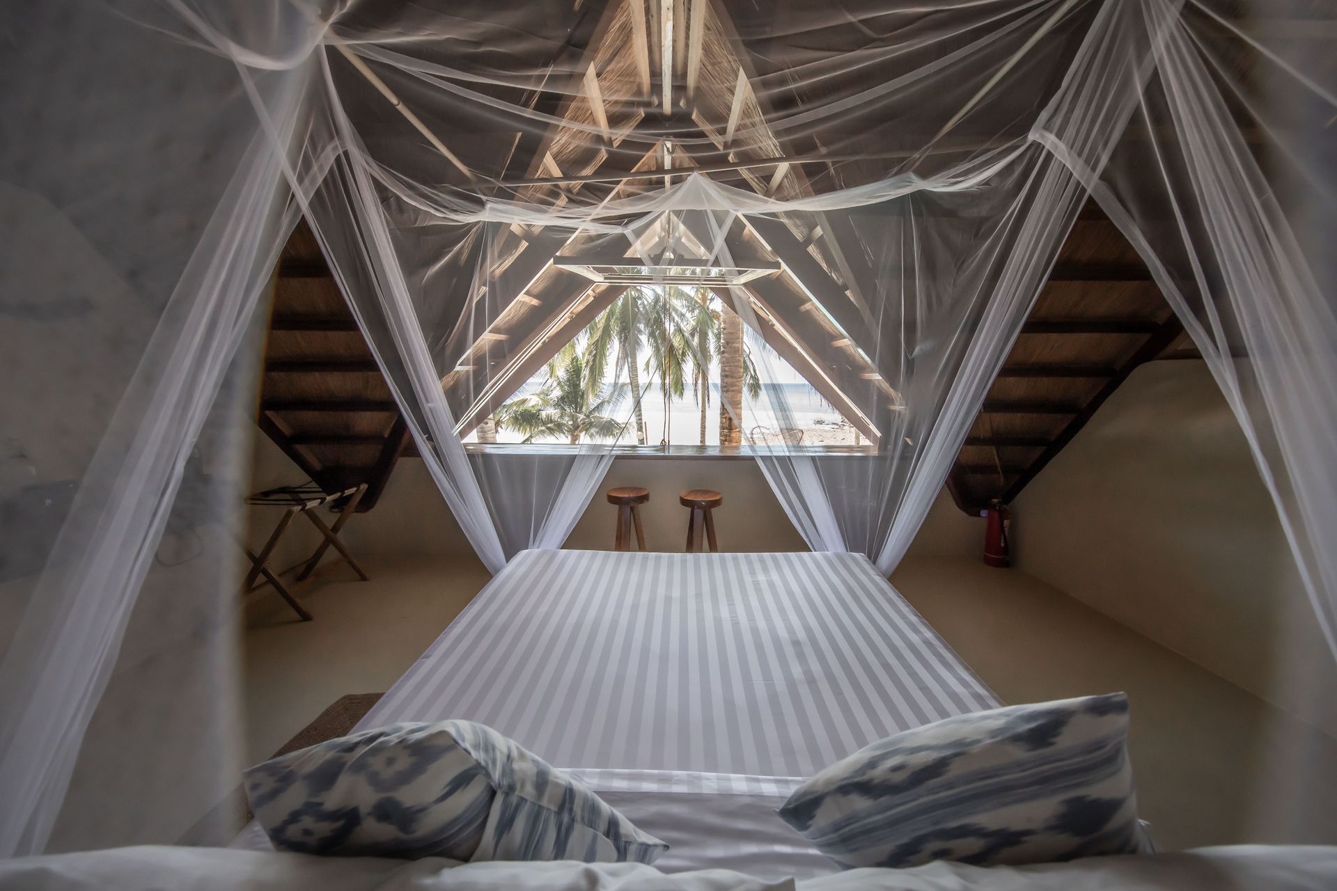 A bedroom with a hammock hanging from the ceiling