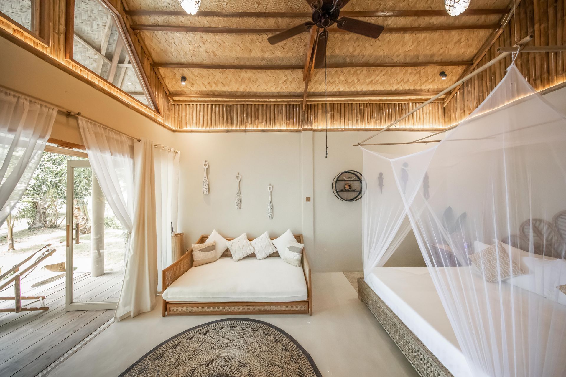 A bedroom with a canopy bed and a ceiling fan.