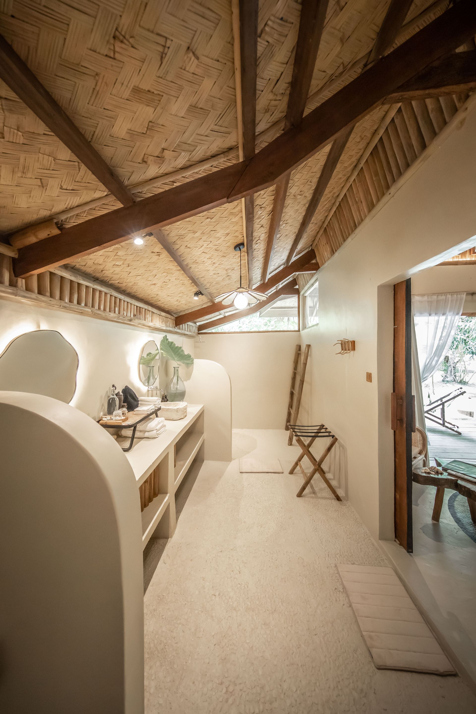 A bathroom with a wooden ceiling and a white floor.