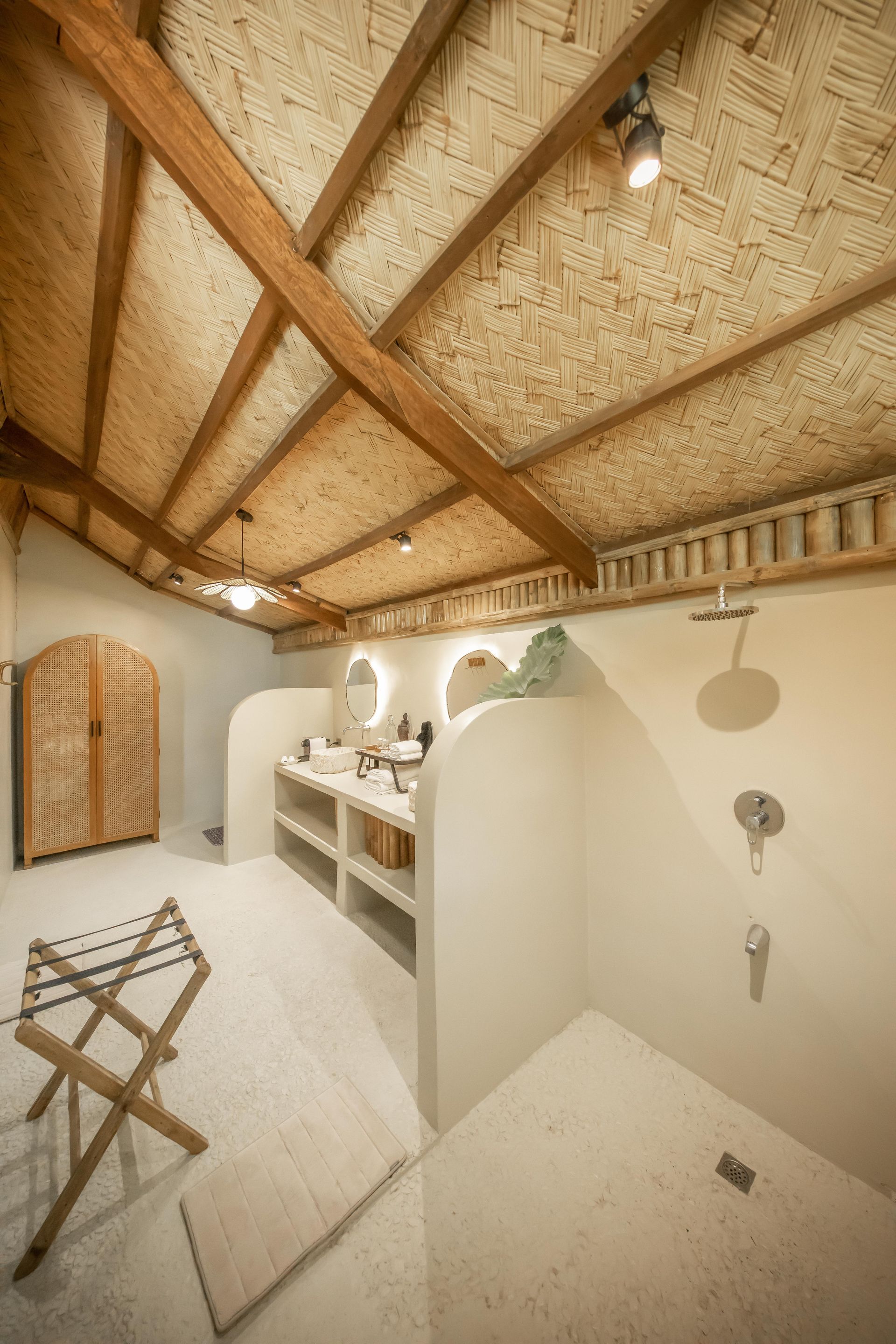 A bathroom with a wooden ceiling and a shower.