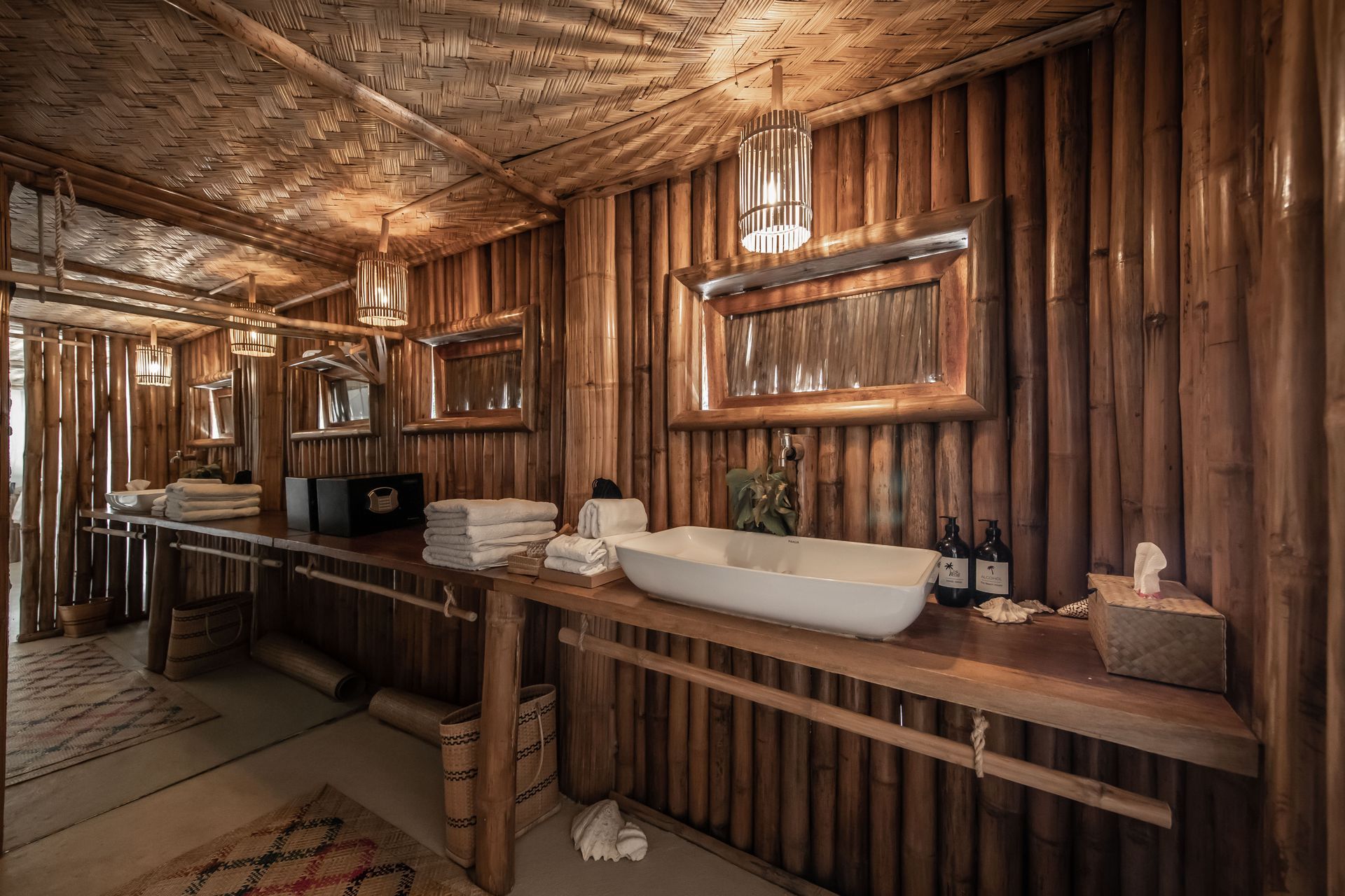 A bathroom with wooden walls and a sink.