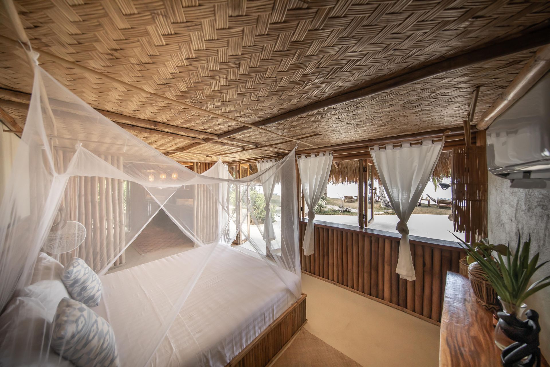 There is a mosquito net over the bed in the room.