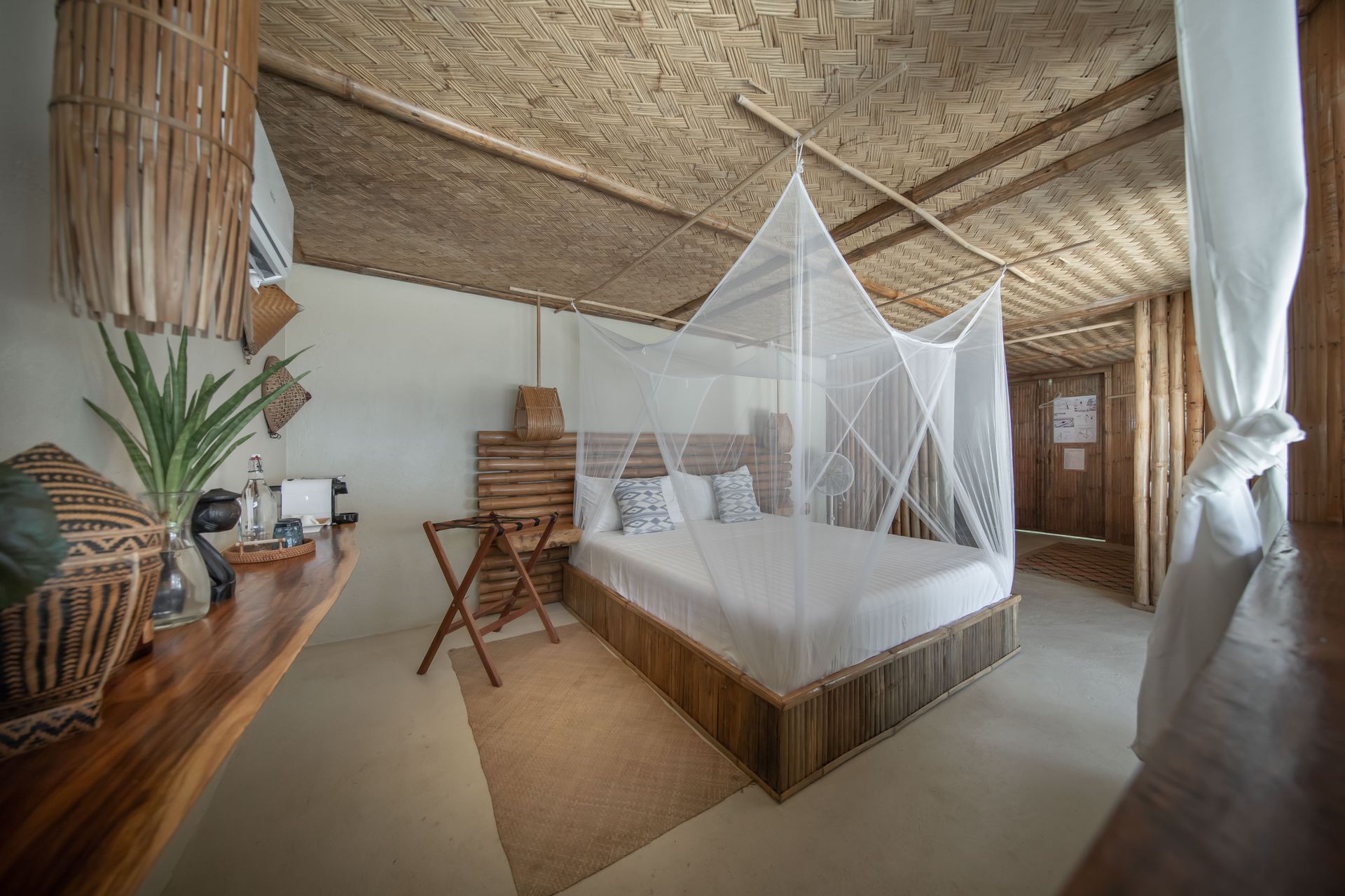A bedroom with a canopy bed and a desk.