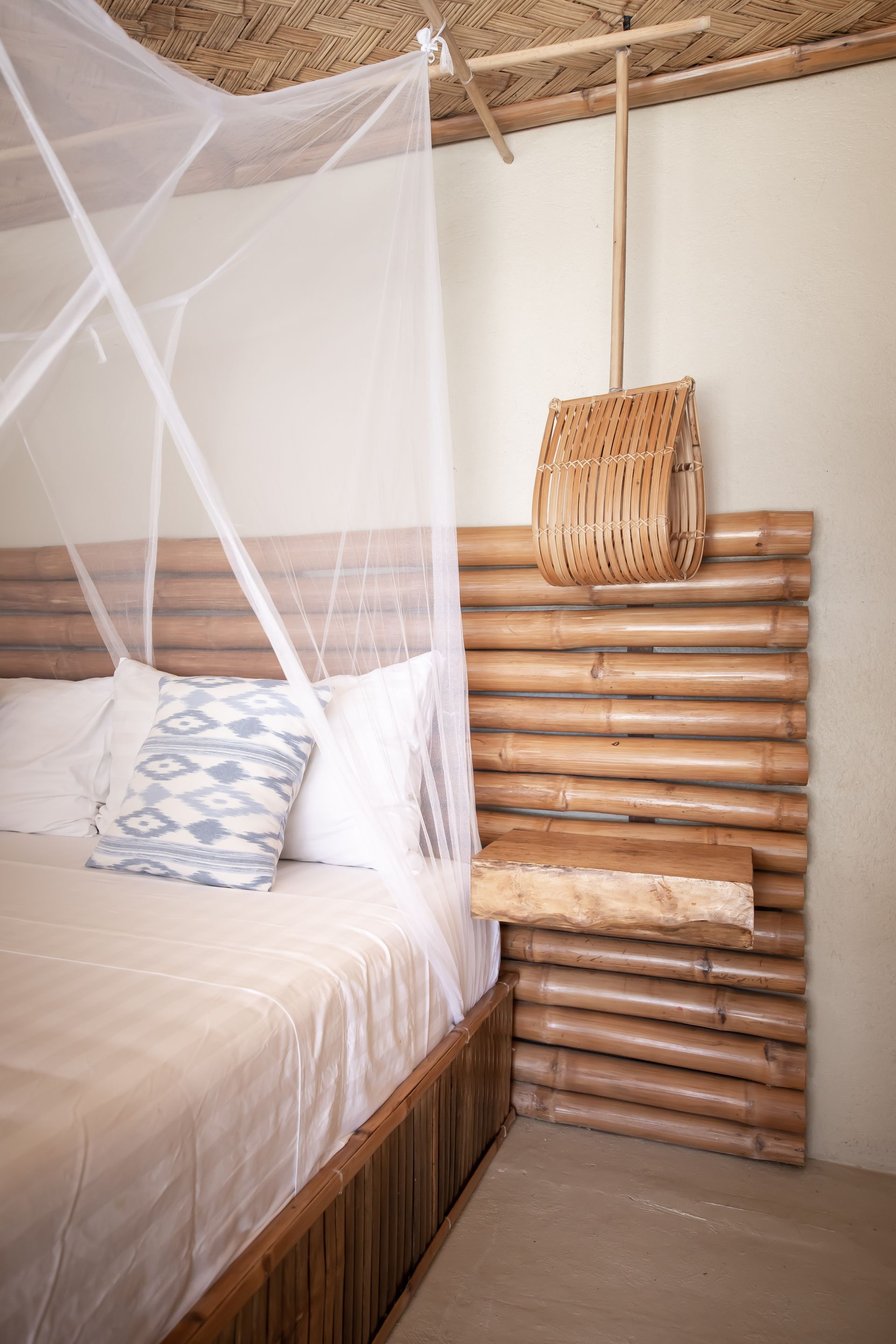 A bedroom with a canopy bed and a wooden headboard.
