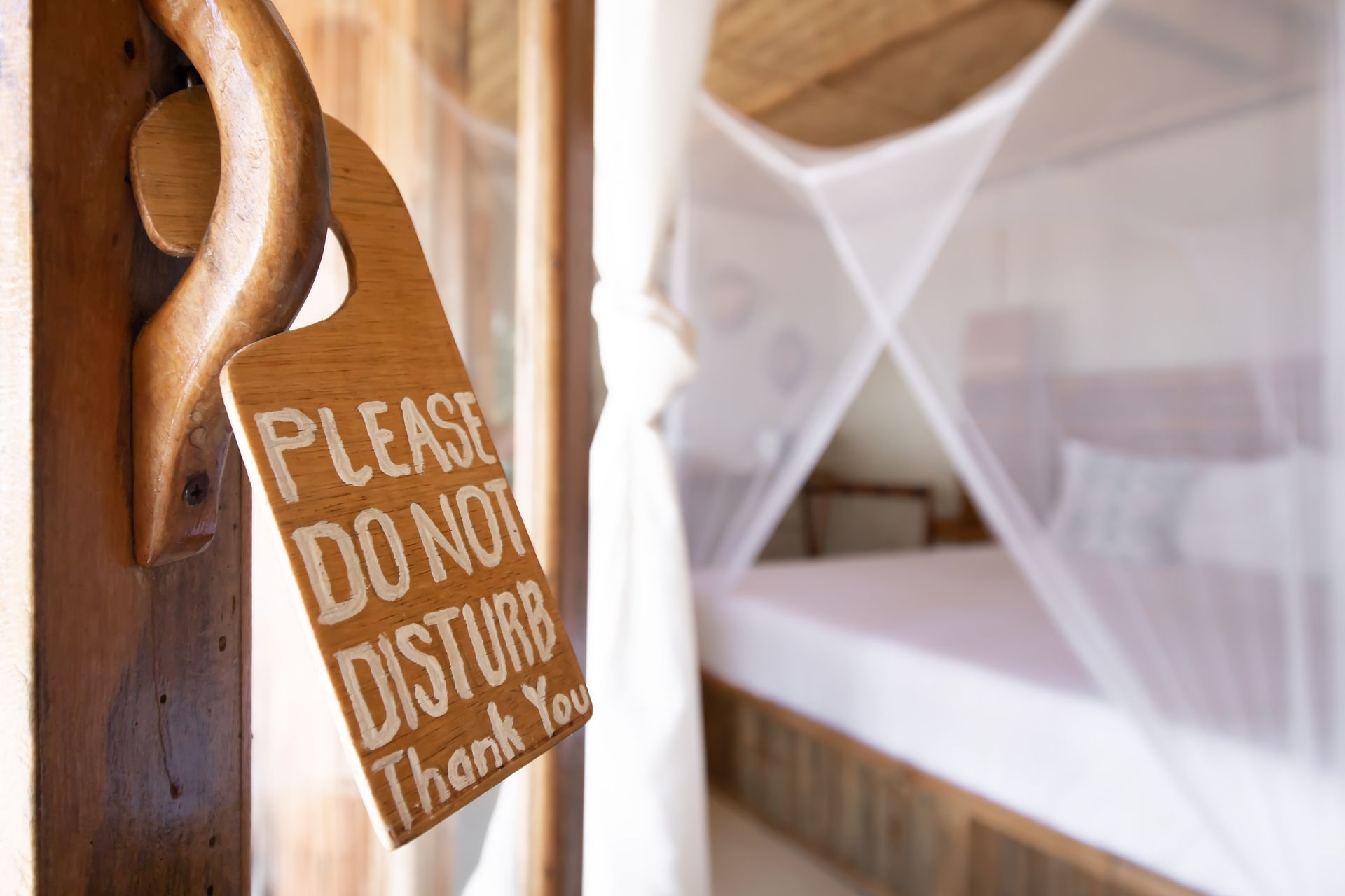 A door with a sign on it that says please do not disturb thank you.