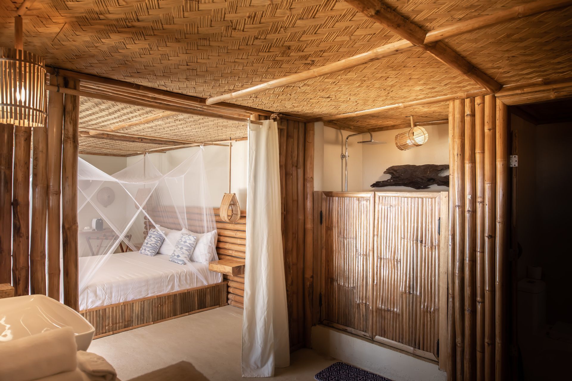 A bedroom with a bed and a mosquito net.