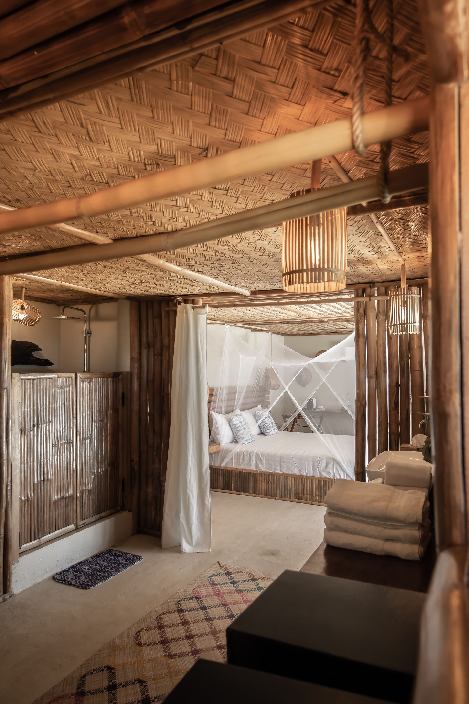 A bedroom with a canopy bed and a wooden ceiling.