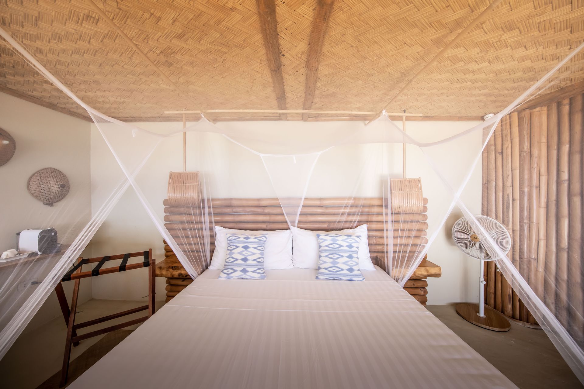 A bedroom with a canopy bed and a wooden headboard.
