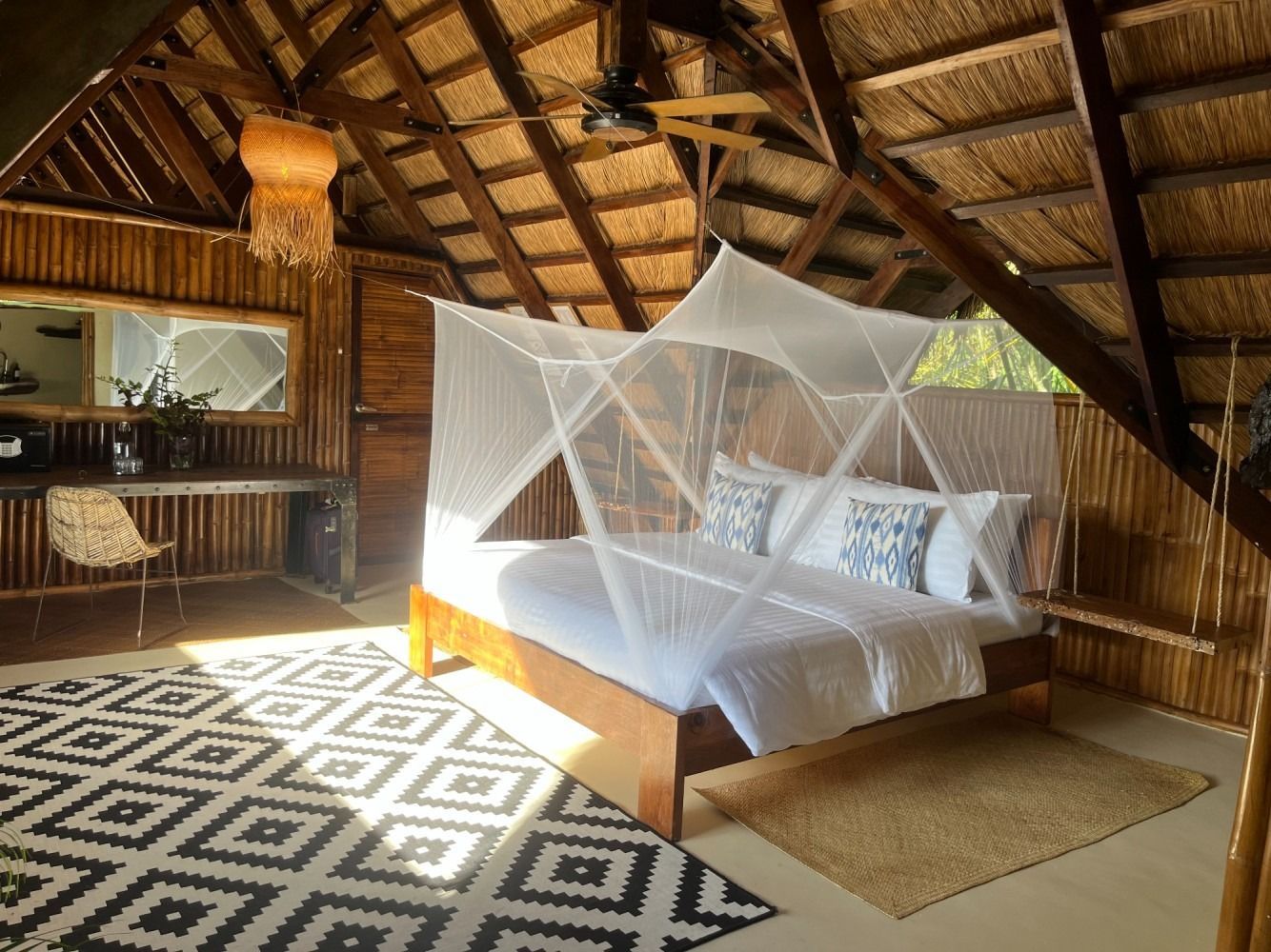 There is a mosquito net over the bed in the room.
