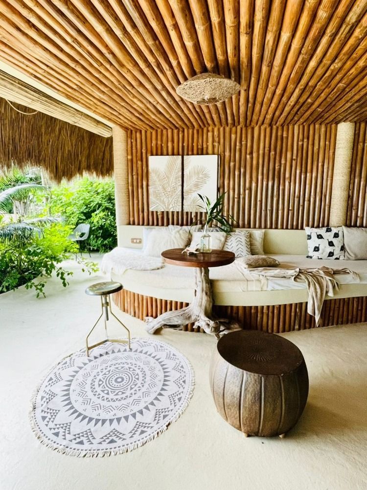 A living room with a couch , table , ottoman and rug.
