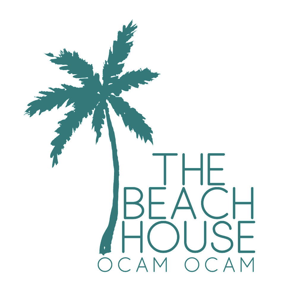 A logo for the beach house ocam ocam with a palm tree