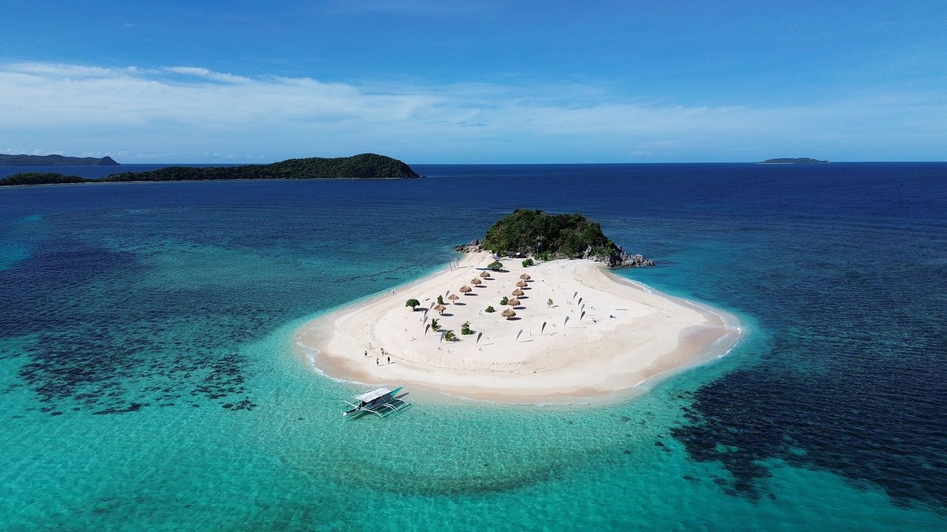 An aerial view of a small island in the middle of the ocean.