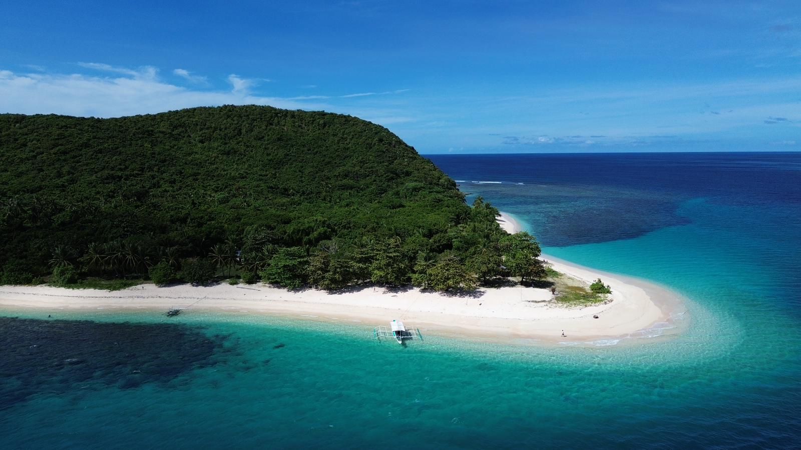An aerial view of a small island in the middle of the ocean.