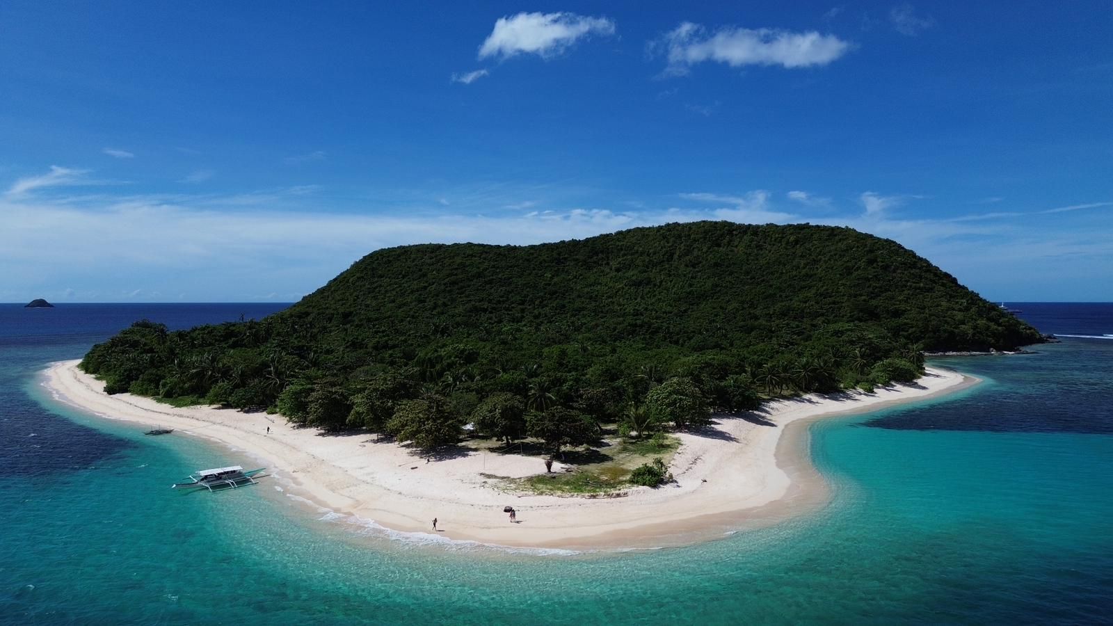 An aerial view of a small island in the middle of the ocean.