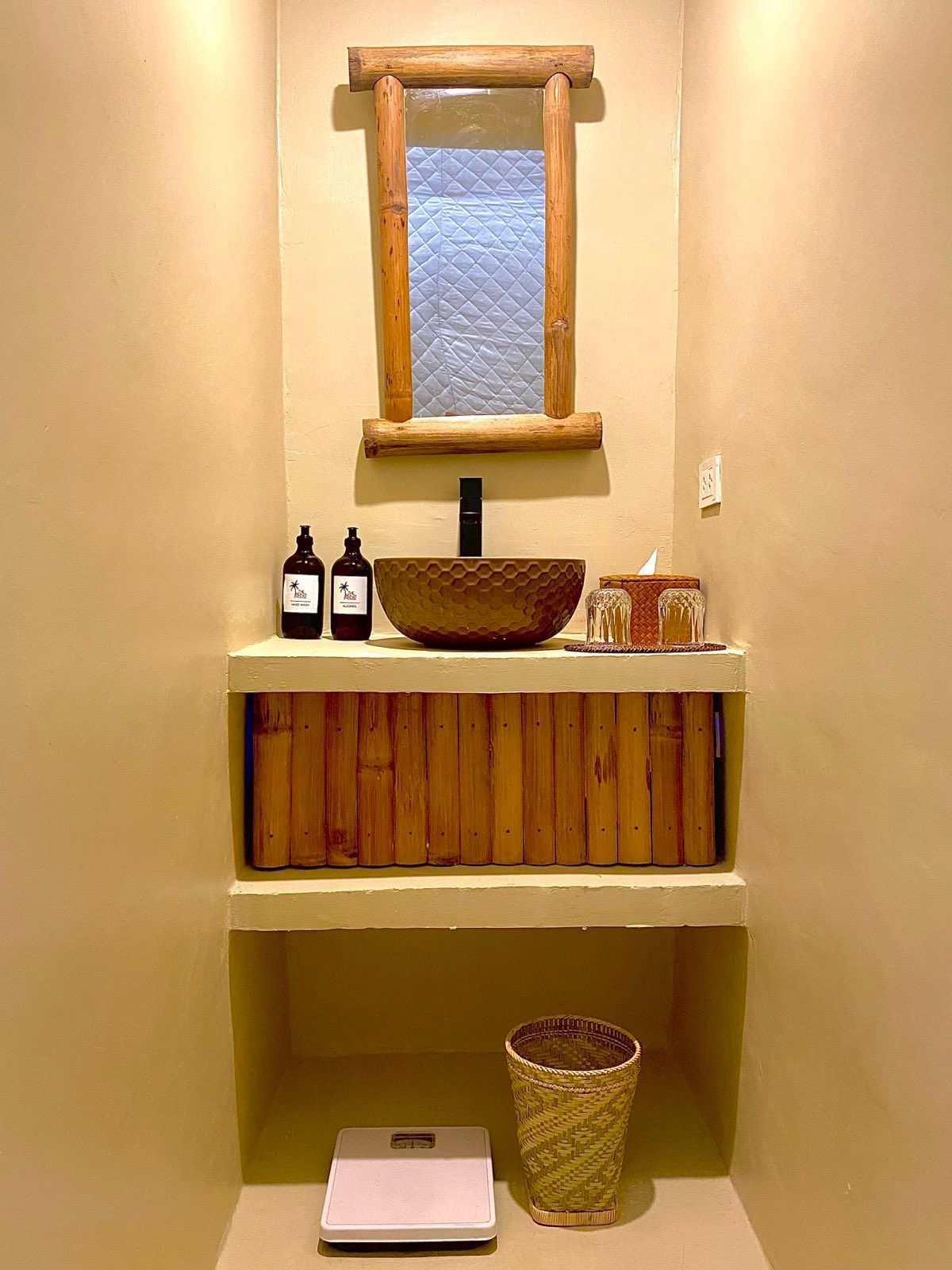 A bathroom with a sink , mirror and scale.