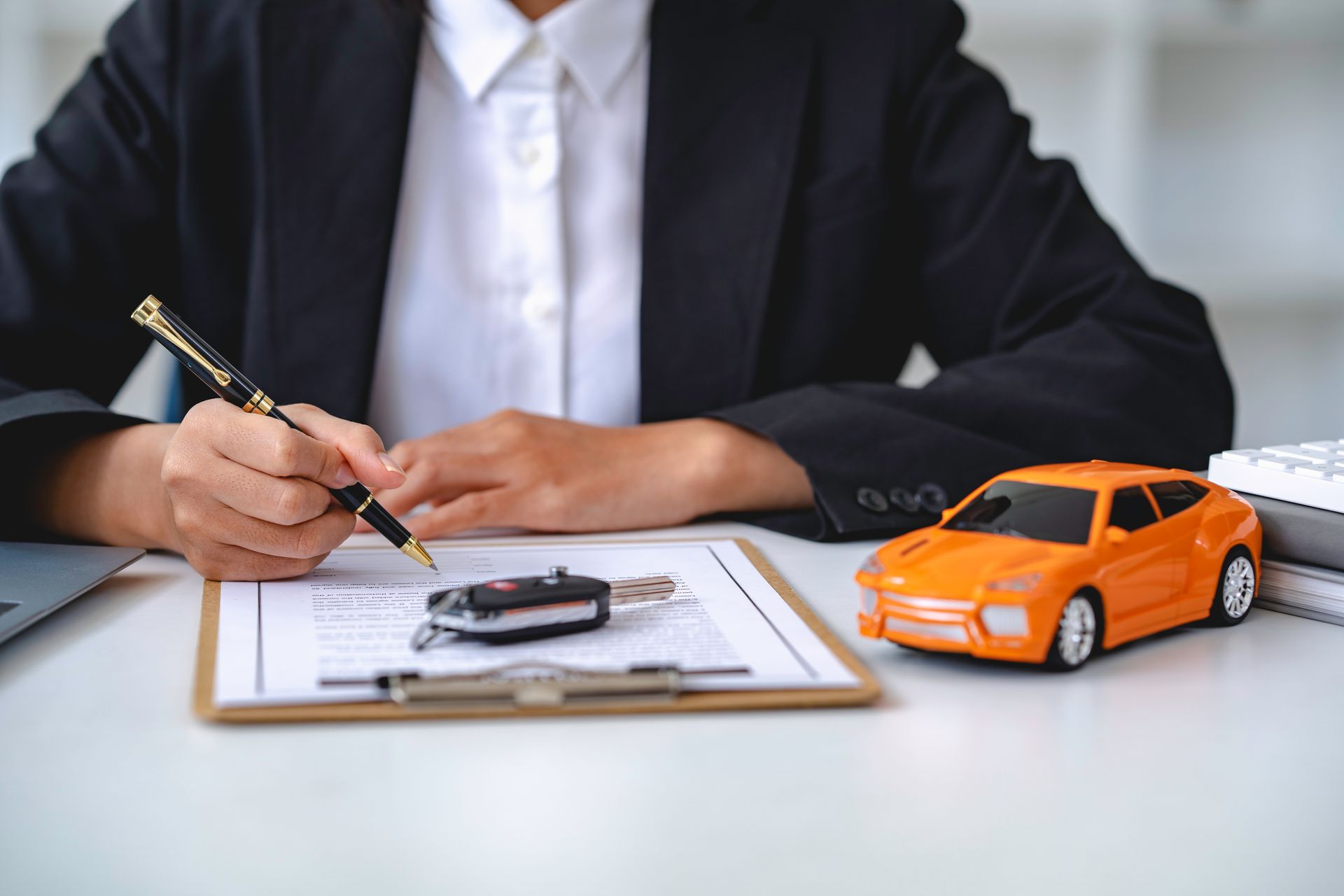 Customer meeting with auto insurance agency representative while shaking hands across desk. Customer meeting with auto insurance agency representative while shaking hands across desk.