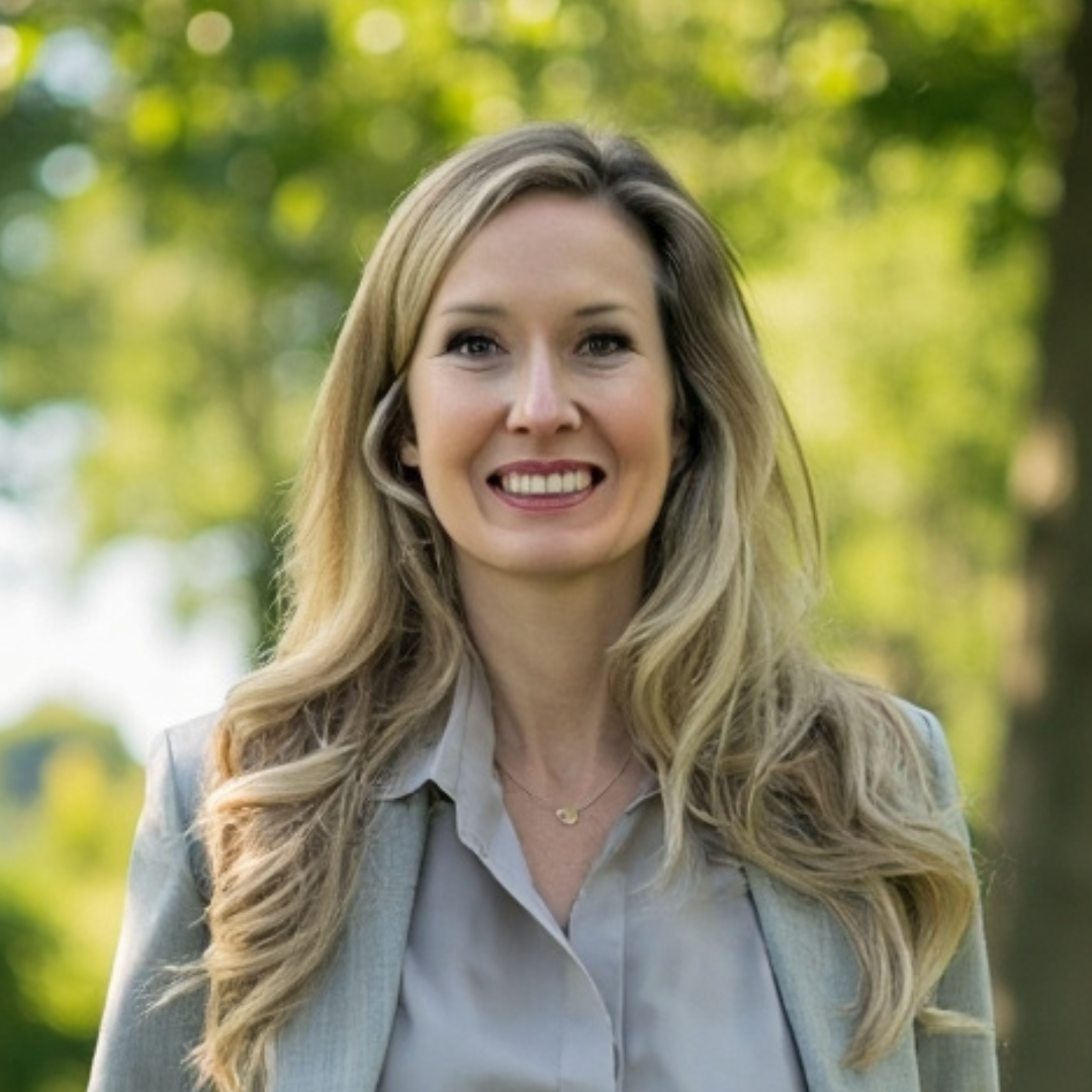 Founder with long blonde hair smiling, wearing a leather jacket. Black and white photo.