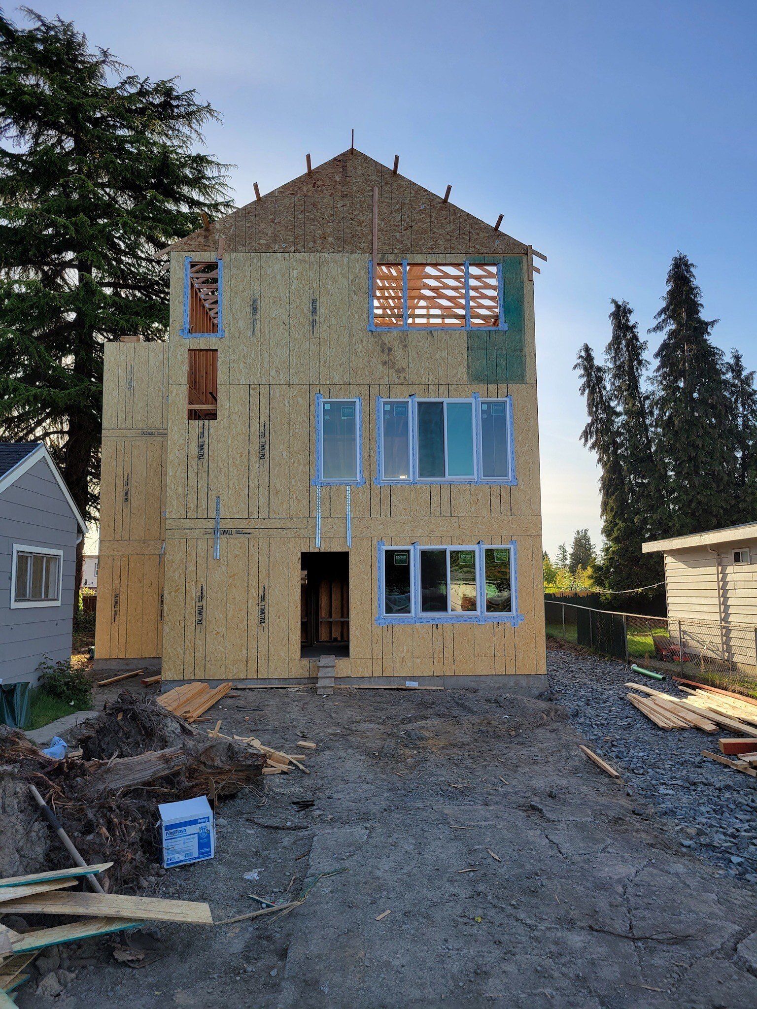 A house is being built in the middle of a dirt field.