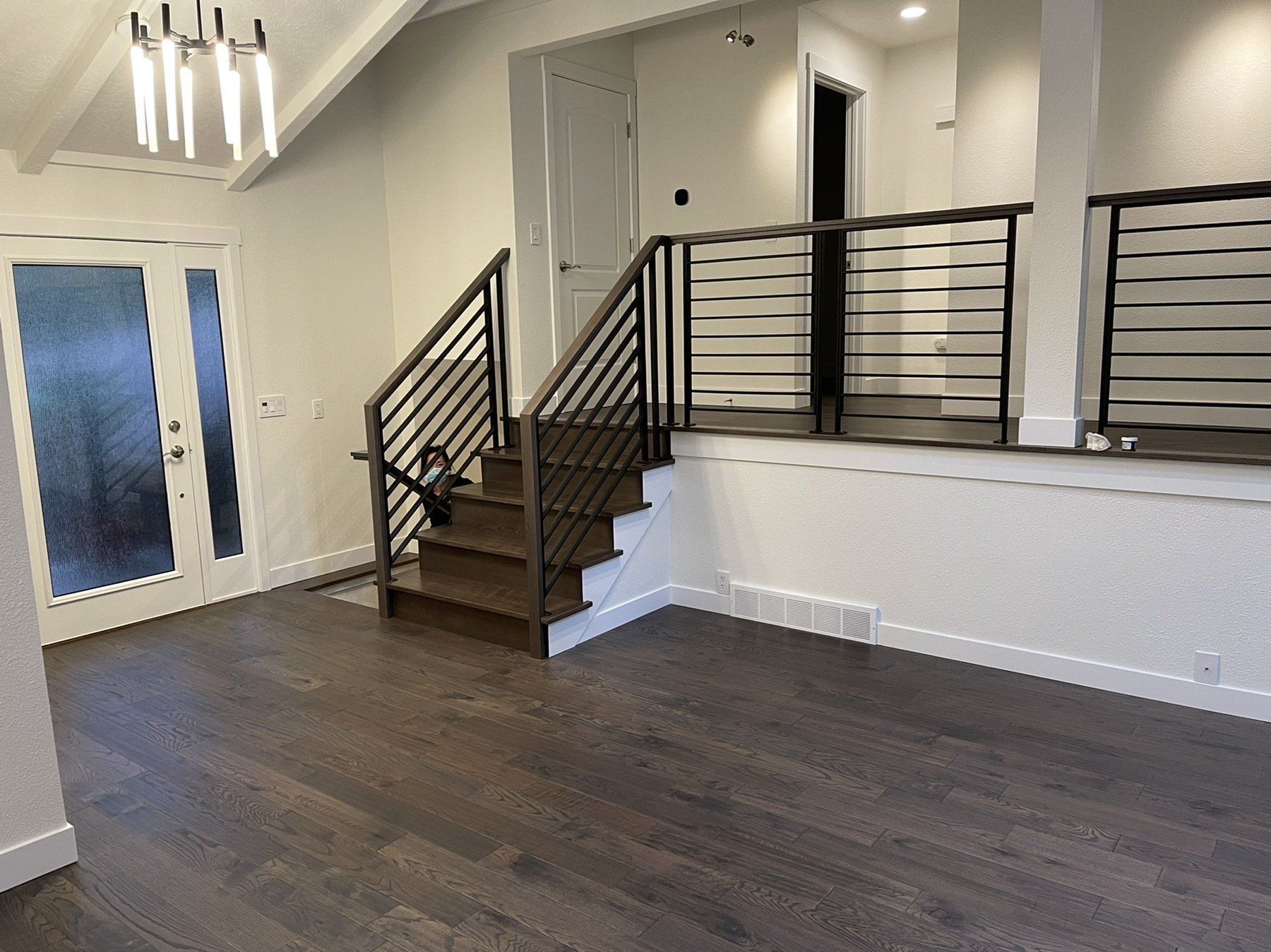 An empty room with stairs leading up to the second floor