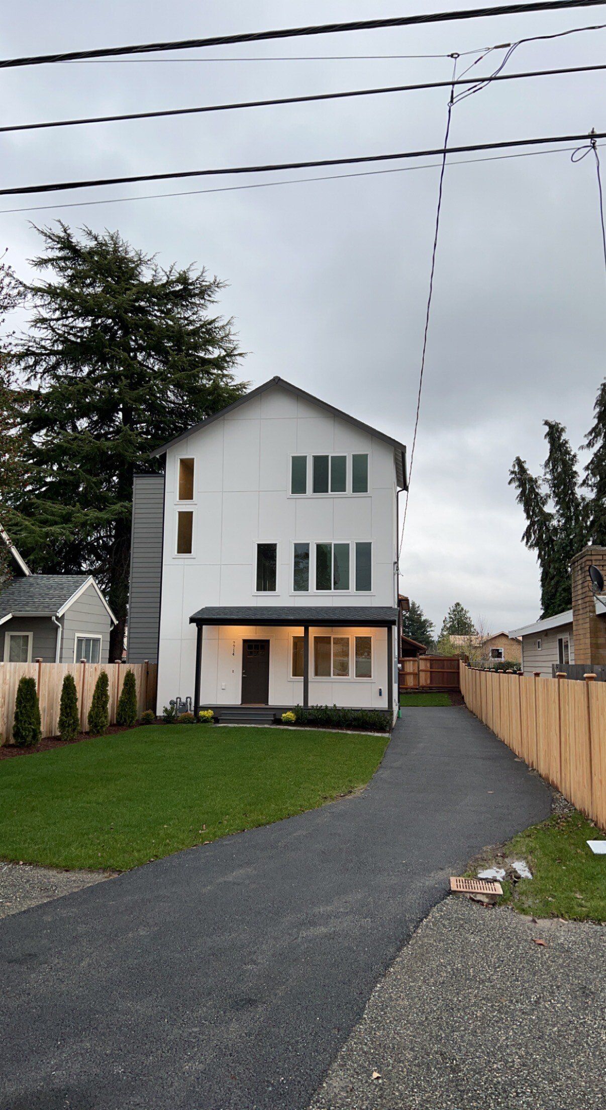 A white house with a driveway leading to it