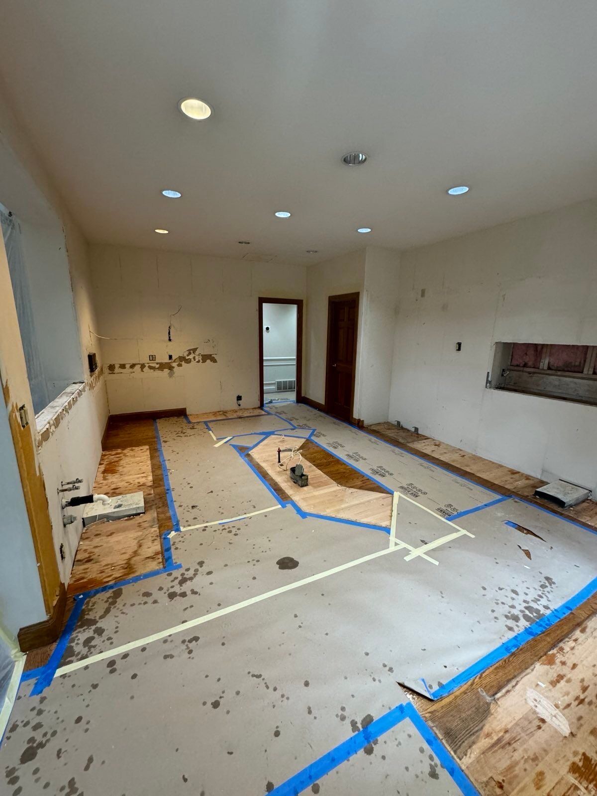 A large room with a lot of tape on the floor.
