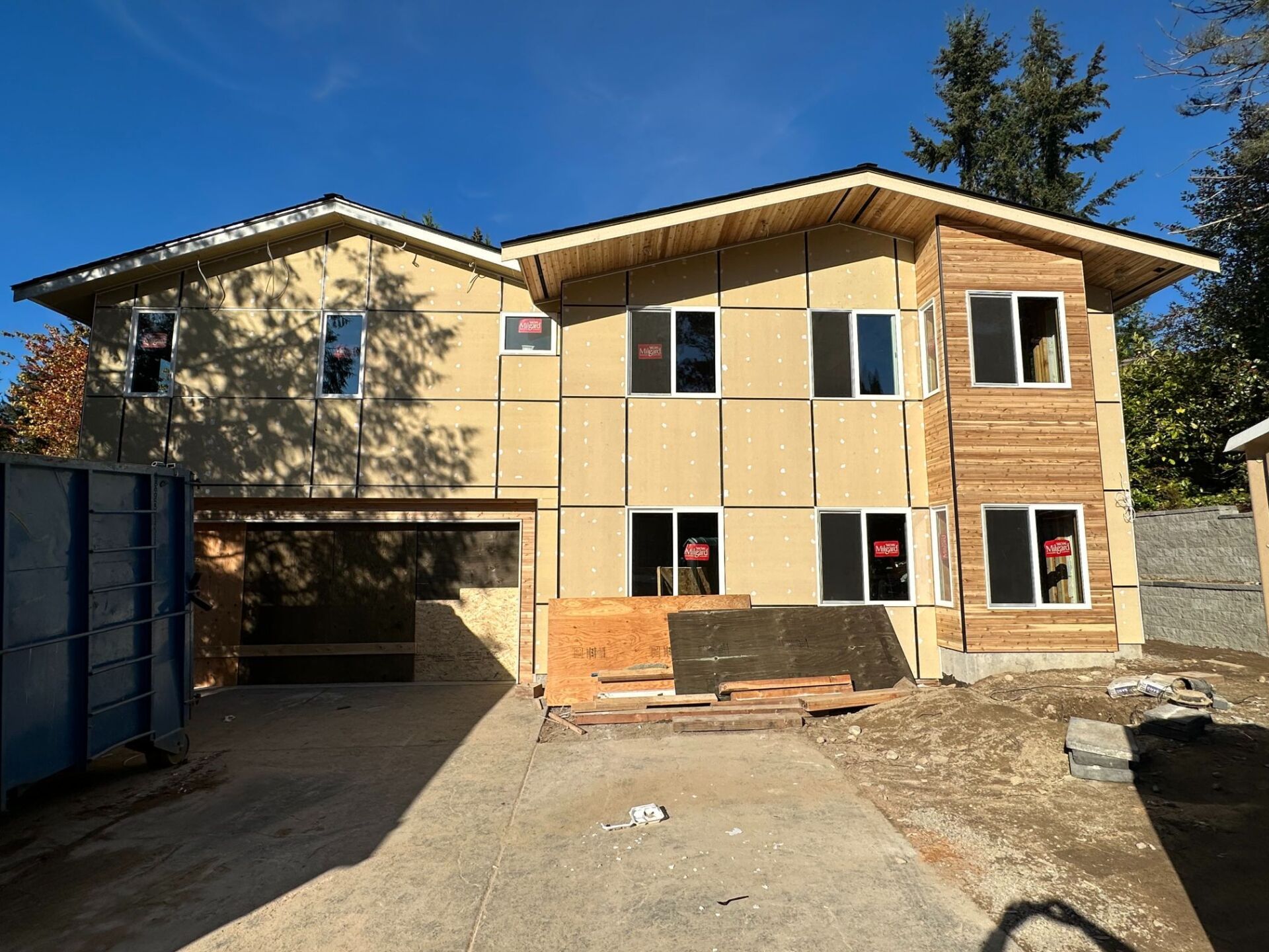 A house that is being built with a lot of windows