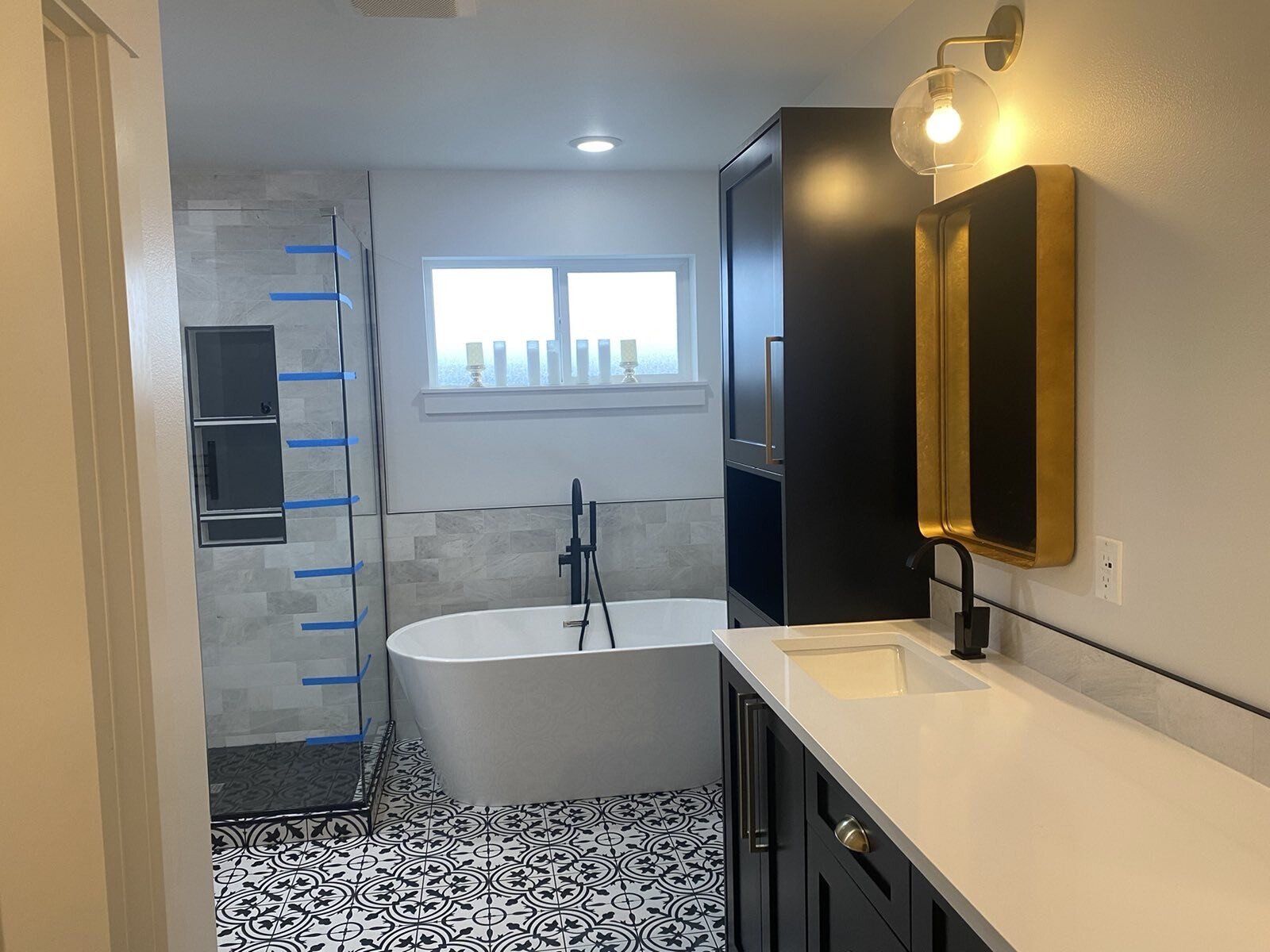 A bathroom with a bathtub , sink , mirror and shower.