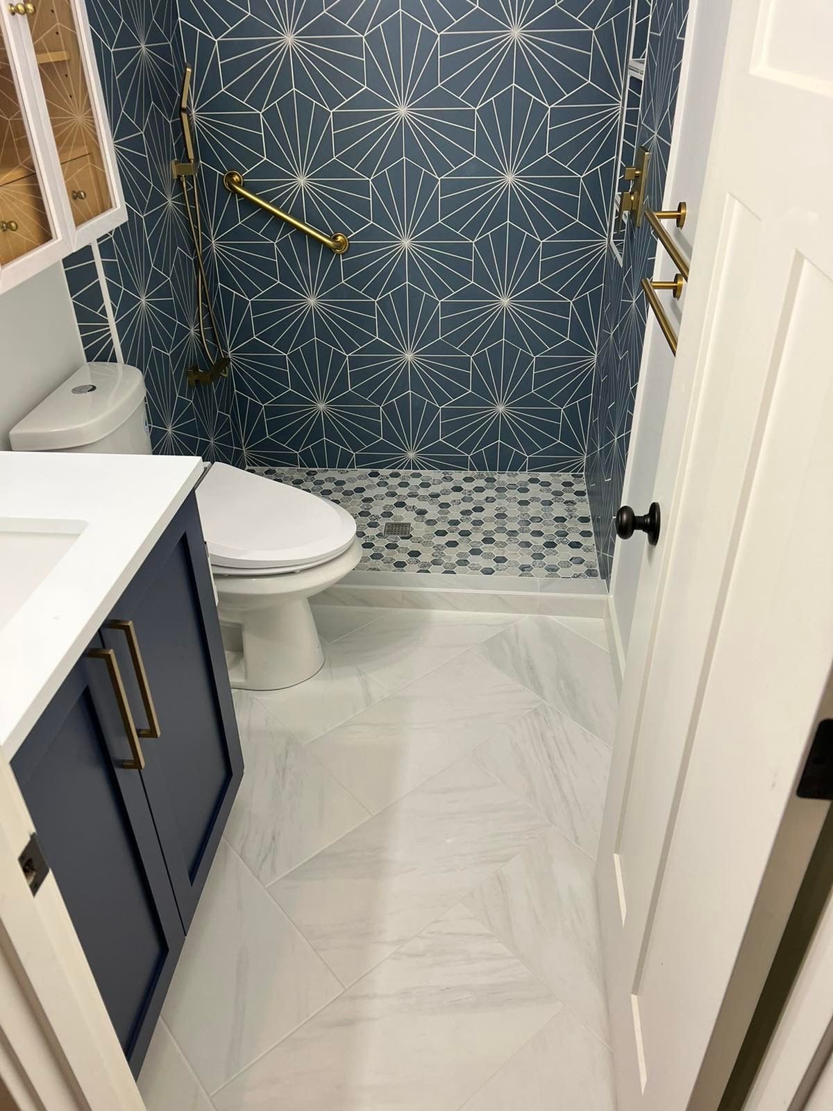 A bathroom with a toilet , sink , and shower.