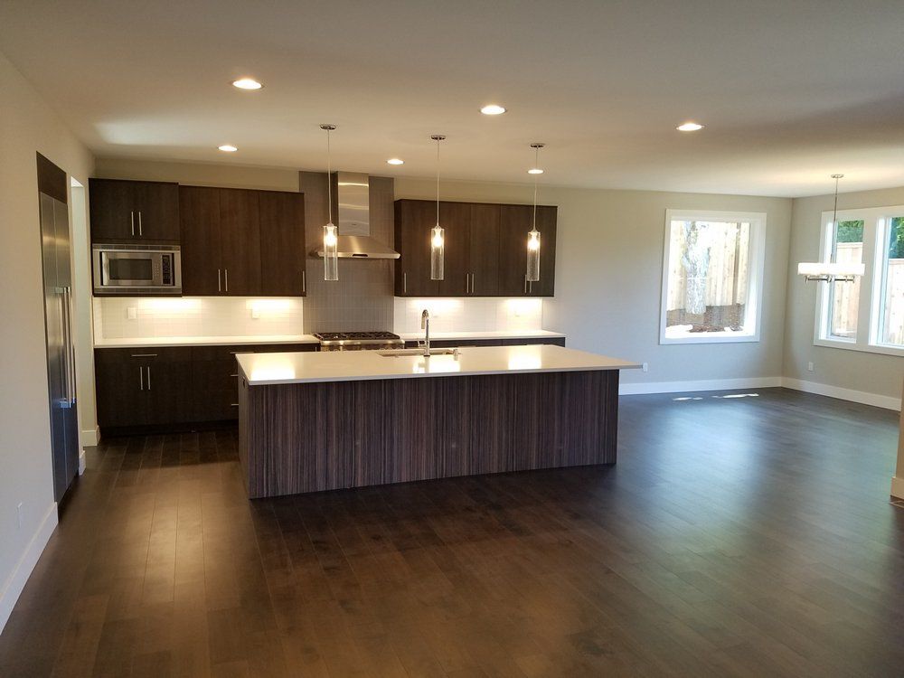 An empty kitchen with a large island in the middle