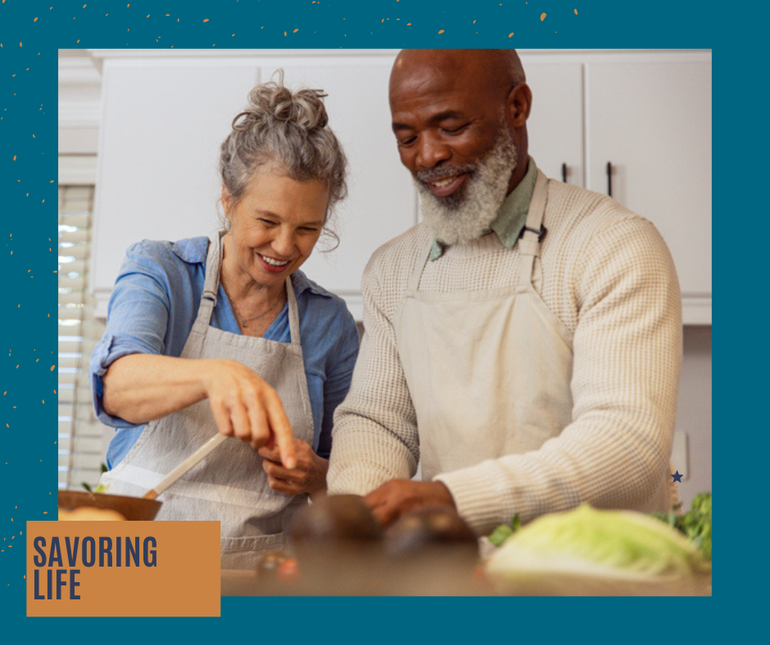 Two people cooking together in a bright kitchen, smiling and stirring food in a pan at EVOQ East Cobb Marietta, GA.