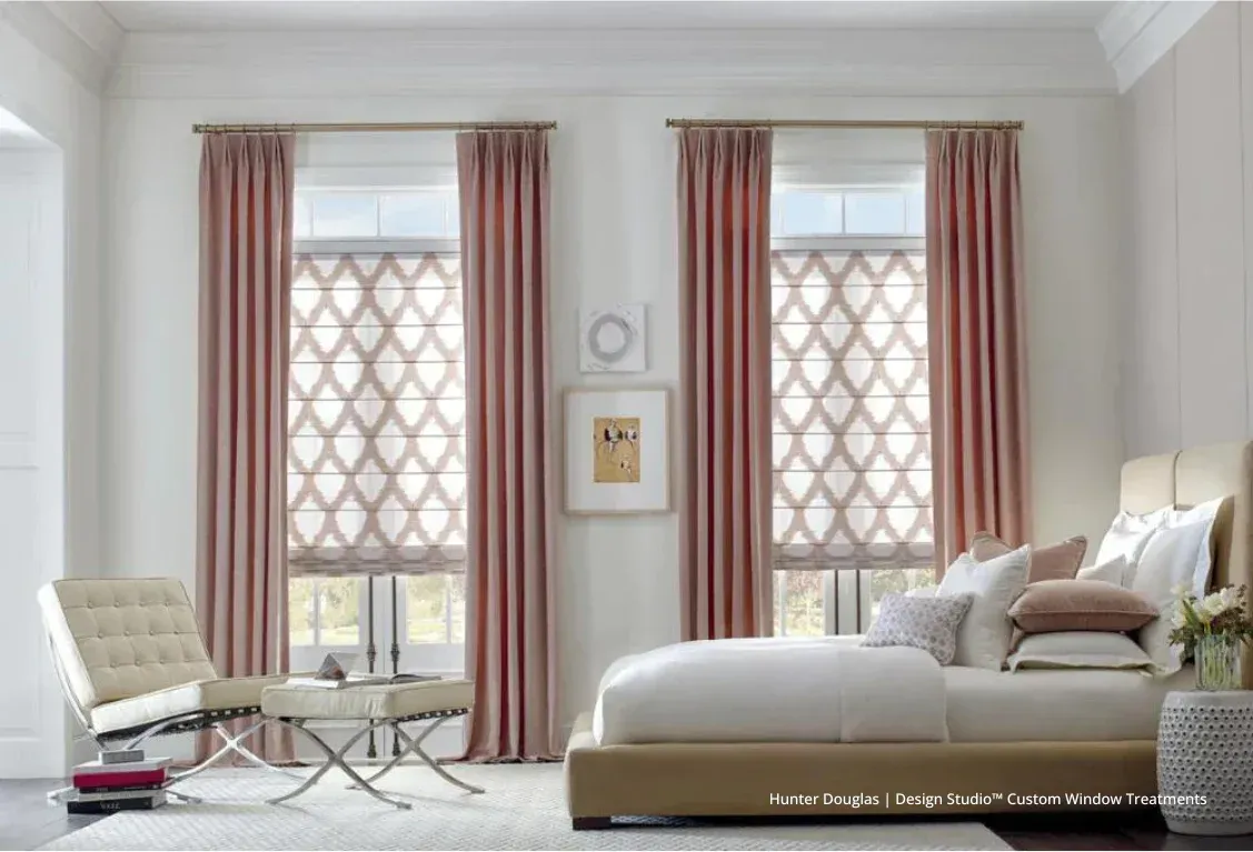 A bedroom with a bed , chair , and two windows.