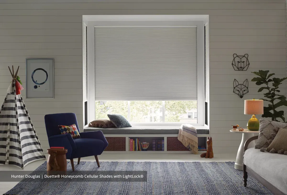 A living room with a window seat and a chair.