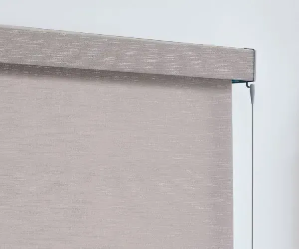 A close up of a roller blind on a window.
