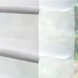 A close up of a white blind on a window.