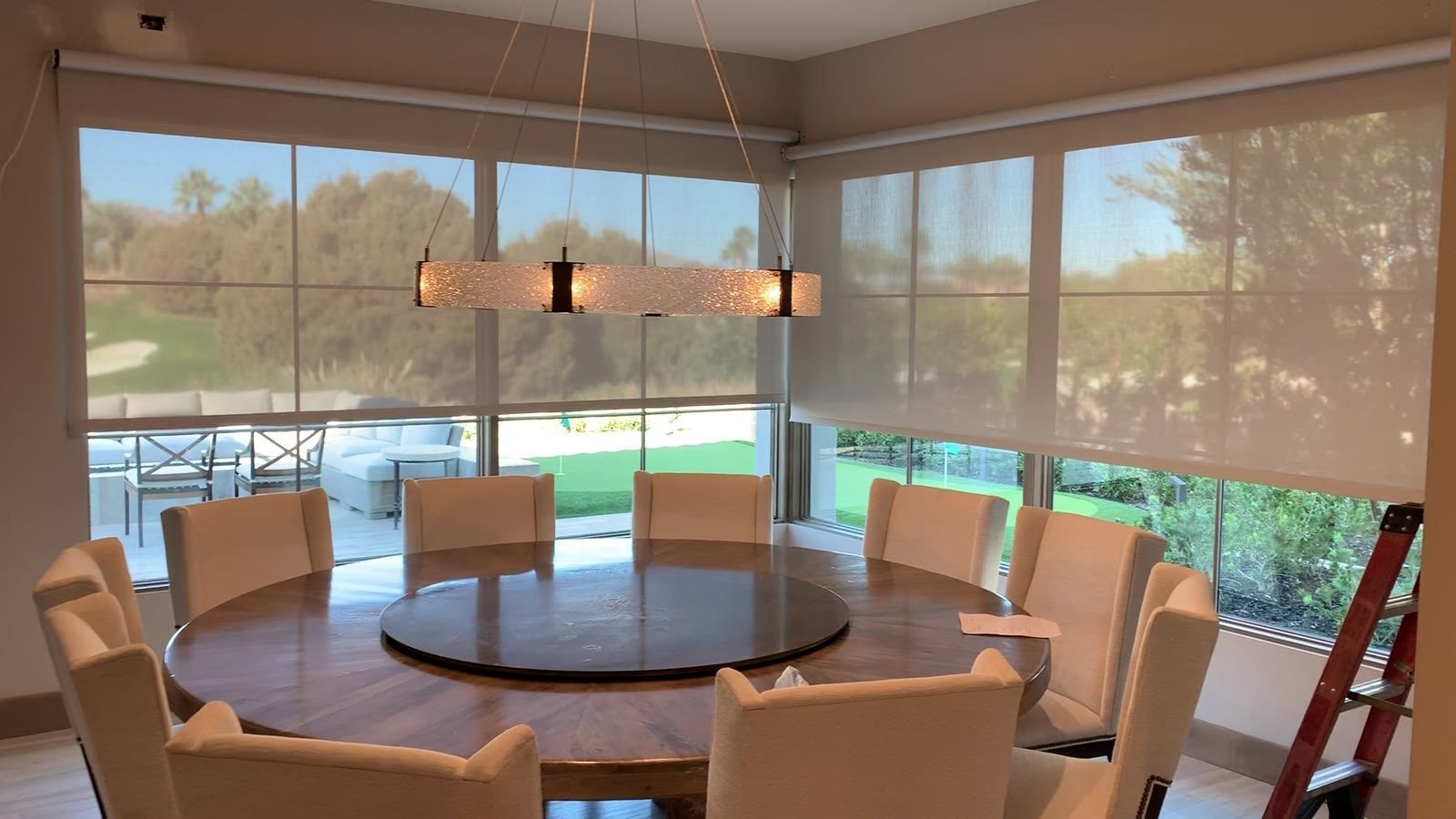 Solar shades on corner windows in a dining room