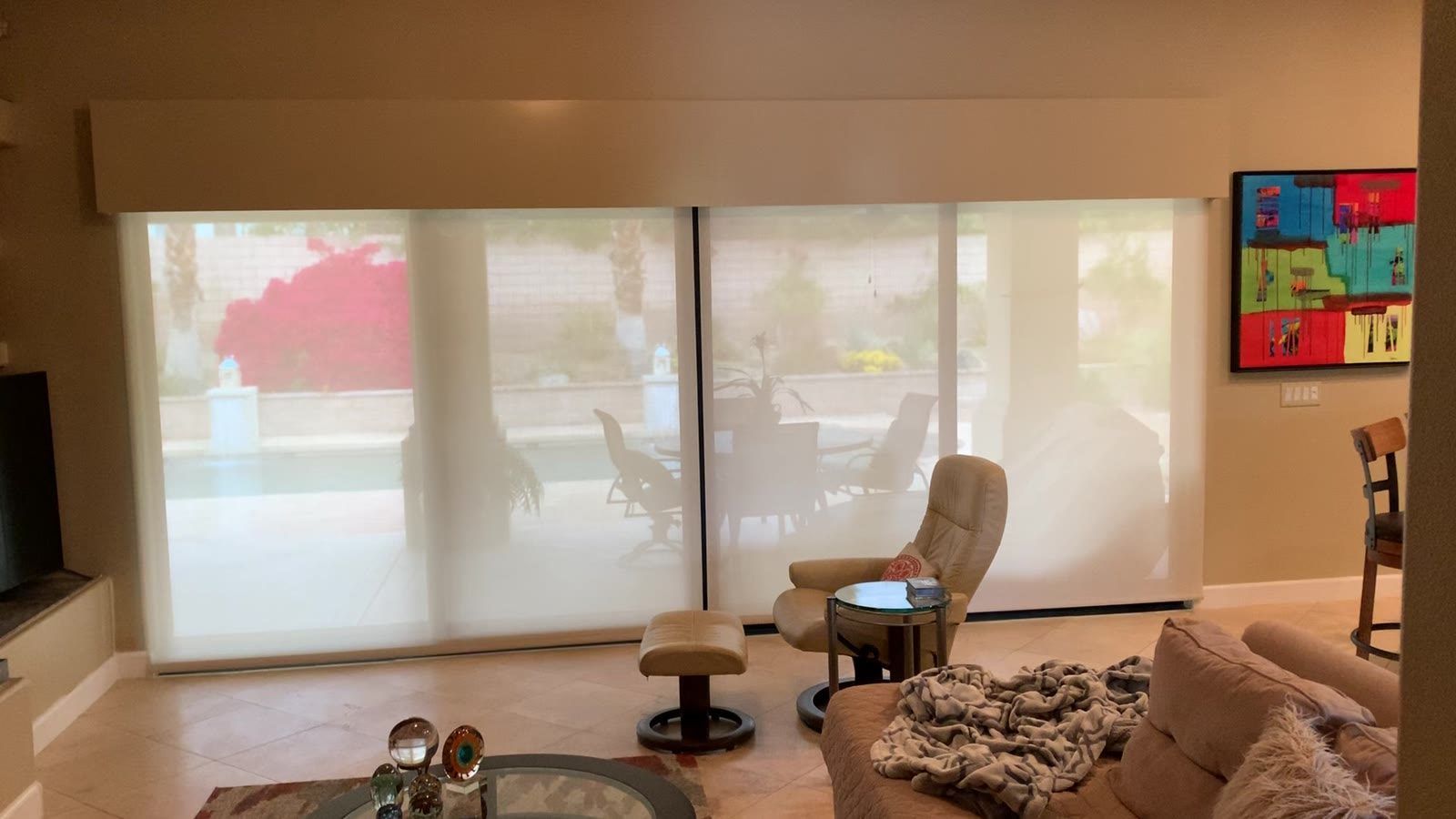 Light-filtering roller shades on sliding doors in a Coachella Valley family room
