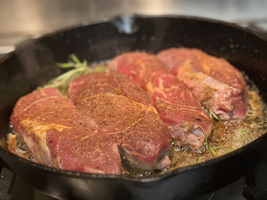 Montana Grass-Fed Beef ad with steak, seasoning bowl, and Taylor Beef Co logo on a dark background