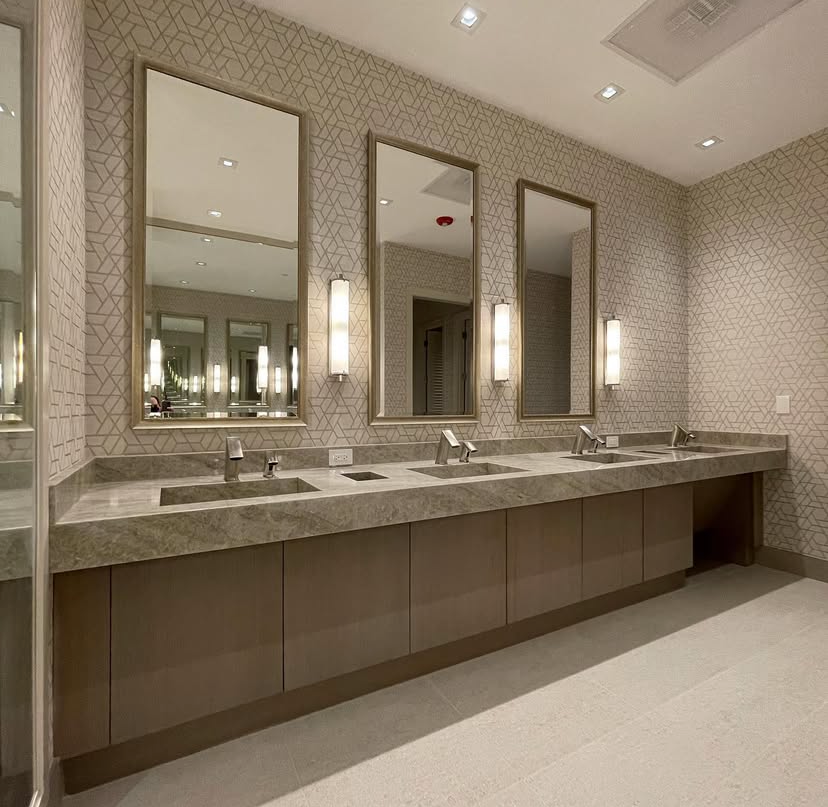 A bathroom with marble walls and a walk in shower
