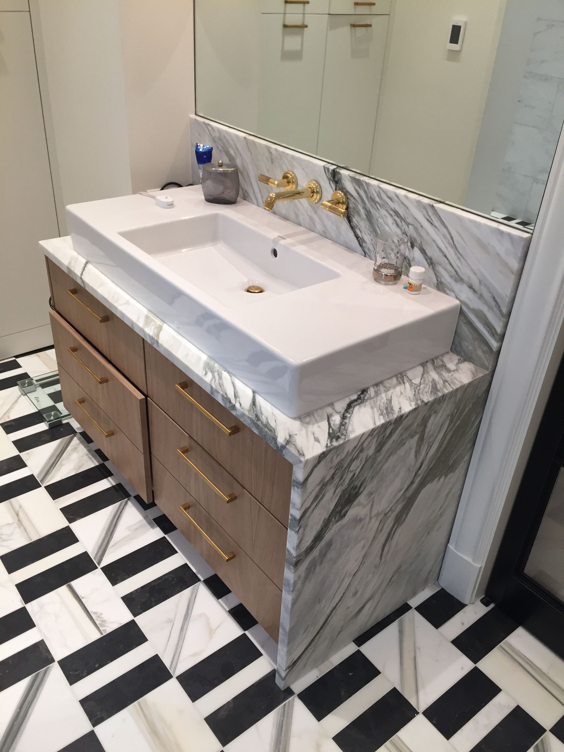 A bathroom with marble tiles and a walk in shower