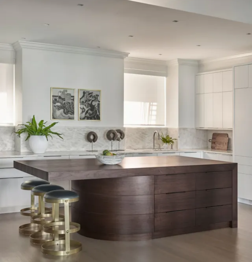 A kitchen with a large island and stools