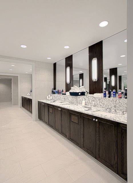 A bathroom with a lot of sinks and mirrors