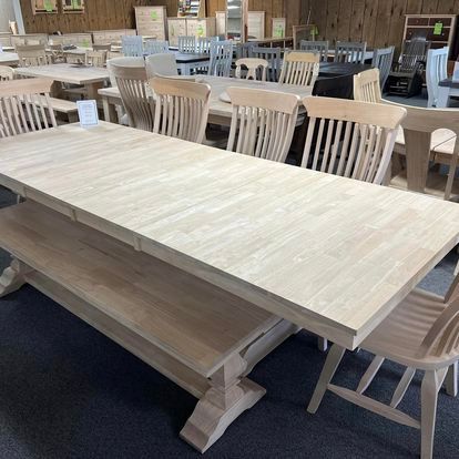 A wooden table and chairs are sitting in a room.