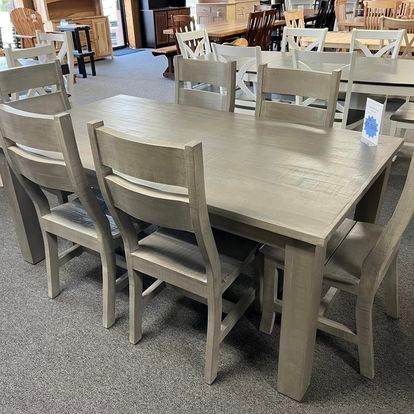 A wooden table and chairs are sitting in a room.