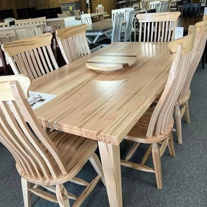 A wooden dining table and chairs in a store