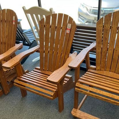 A group of wooden chairs are sitting in a room.