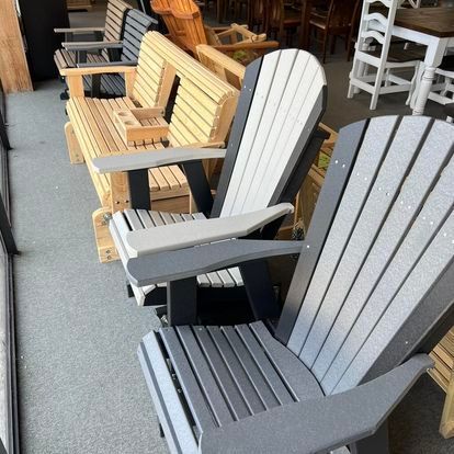 A row of wooden adirondack chairs in a store.