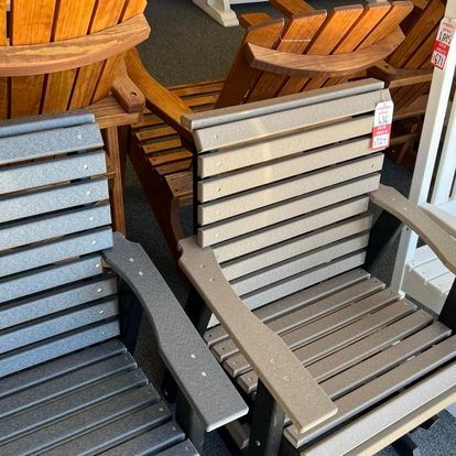 A group of wooden chairs are sitting next to each other in a room.