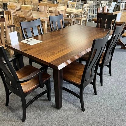 A wooden table and chairs are sitting in a room.