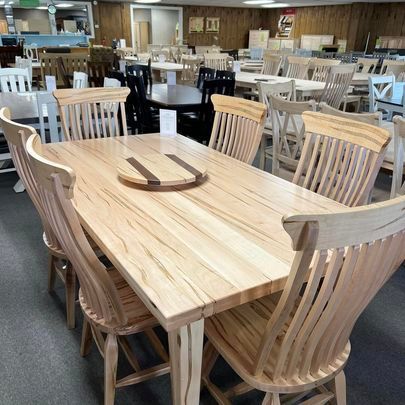 A wooden table and chairs are sitting in a room.