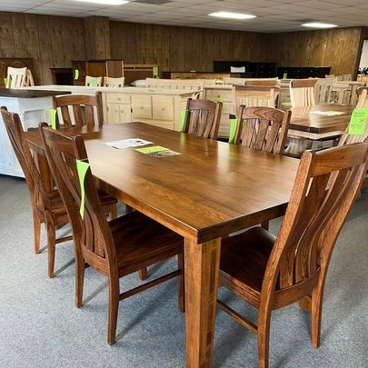 A wooden table and chairs are sitting in a room.